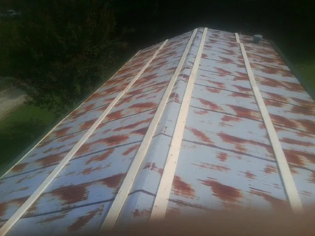 Rusted metal roof panels with new wood purlins before replacement — Storm Damage Roof Repair in New Gloucester by Roofing Brothers