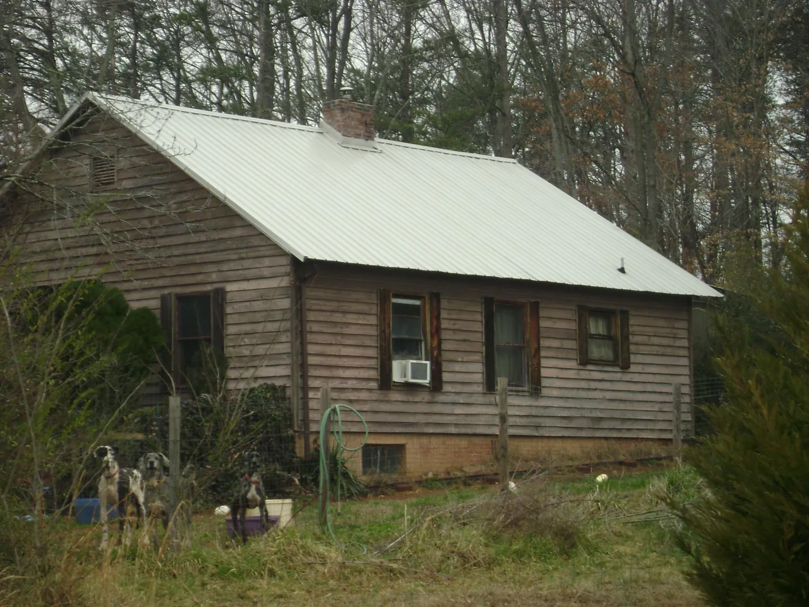 White metal roof on an old wood sided farmhouse, from a Metal Roof Installation job in New Gloucester